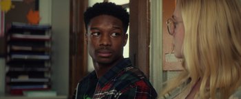 Movie still from “All the Bright Places” (2020), directed by Brett Haley – A man in a plaid shirt is looking at the camera; Close Up shot, Over the shoulder angle