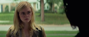 Movie still from “All the Bright Places” (2020), directed by Brett Haley – A woman wearing glasses and a brown jacket; Close Up shot, Over the shoulder angle