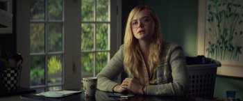 Movie still from “All the Bright Places” (2020), directed by Brett Haley – A woman sitting at a table in front of a window; Medium shot, Over the shoulder angle