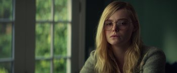 Movie still from “All the Bright Places” (2020), directed by Brett Haley – A woman with glasses sitting in front of a window; Close Up shot, Over the shoulder angle