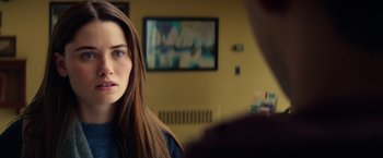 Movie still from “All the Bright Places” (2020), directed by Brett Haley – A woman with long brown hair stares into the camera; Close Up shot, Over the shoulder angle