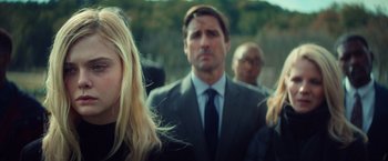 Movie still from “All the Bright Places” (2020), directed by Brett Haley – A group of people standing next to each other in suits; Close Up shot, Over the shoulder angle