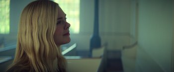 Movie still from “All the Bright Places” (2020), directed by Brett Haley – A woman sitting in front of a window looking off to the side; Close Up shot, Over the shoulder angle