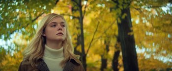 Movie still from “All the Bright Places” (2020), directed by Brett Haley – A young blonde woman in a white sweater and a brown jacket; Medium shot, Low angle
