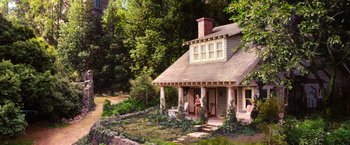 Movie still from “The Great Gatsby” (2013), directed by Baz Luhrmann – A woman standing on the porch of a house; Extreme Wide shot, High angle