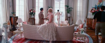 Movie still from “The Great Gatsby” (2013), directed by Baz Luhrmann – A man and a woman are standing in a living room; Wide shot, Low angle