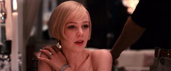 Movie still from “The Great Gatsby” (2013), directed by Baz Luhrmann – A beautiful young woman with short blonde hair; Close Up shot, Over the shoulder angle