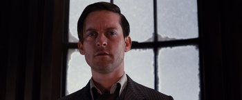 Movie still from “The Great Gatsby” (2013), directed by Baz Luhrmann – A person wearing a suit and tie; Close Up shot, Low angle