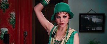 Movie still from “The Great Gatsby” (2013), directed by Baz Luhrmann – A woman wearing a green hat and a green dress; Close Up shot, Low angle