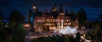 Movie still from “The Great Gatsby” (2013), directed by Baz Luhrmann – A group of people standing in front of a building; Extreme Wide shot, High angle