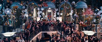 Movie still from “The Great Gatsby” (2013), directed by Baz Luhrmann – A large group of people gathered in a room; Extreme Wide shot, High angle
