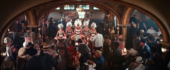 Movie still from “The Great Gatsby” (2013), directed by Baz Luhrmann – A group of women in costumes performing on a stage; Wide shot, High angle