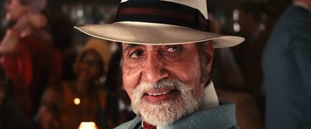 Movie still from “The Great Gatsby” (2013), directed by Baz Luhrmann – An old man with a beard wearing a hat; Close Up shot, Low angle