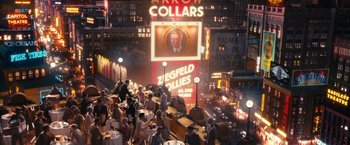 Movie still from “The Great Gatsby” (2013), directed by Baz Luhrmann – A crowd of people standing around tables in front of a building; Wide shot, High angle