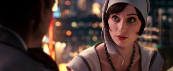 Movie still from “The Great Gatsby” (2013), directed by Baz Luhrmann – A person wearing a hat with lights in the background; Close Up shot, Over the shoulder angle