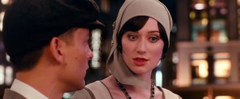Movie still from “The Great Gatsby” (2013), directed by Baz Luhrmann – A woman wearing a hat and a dress; Close Up shot, Over the shoulder angle