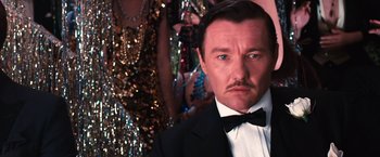 Movie still from “The Great Gatsby” (2013), directed by Baz Luhrmann – A person wearing a suit and a bow tie; Close Up shot, Low angle