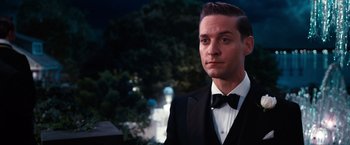 Movie still from “The Great Gatsby” (2013), directed by Baz Luhrmann – A man in a suit and bow tie; Close Up shot, Low angle