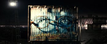 Movie still from “The Great Gatsby” (2013), directed by Baz Luhrmann – An artistic mural of a man's face with glasses on it; Extreme Close Up shot, Low angle