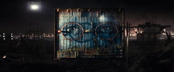 Movie still from “The Great Gatsby” (2013), directed by Baz Luhrmann – An artistic mural of a man's face with glasses; Extreme Close Up shot, Over the shoulder angle