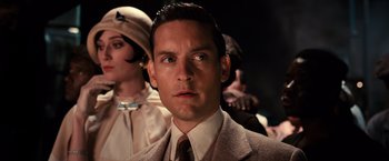Movie still from “The Great Gatsby” (2013), directed by Baz Luhrmann – A person wearing a suit and tie; Close Up shot, Low angle