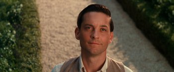 Movie still from “The Great Gatsby” (2013), directed by Baz Luhrmann – A person wearing a shirt and vest; Close Up shot, Over the shoulder angle