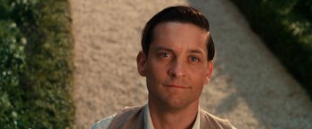 Movie still from “The Great Gatsby” (2013), directed by Baz Luhrmann – A person wearing a suit and tie; Close Up shot, Over the shoulder angle