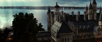 Movie still from “The Great Gatsby” (2013), directed by Baz Luhrmann – A castle with a lake in the background at night; Extreme Wide shot, High angle