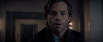 Movie still from “All the Old Knives” (2022), directed by Janus Metz – A person wearing a suit and tie; Close Up shot, Over the shoulder angle