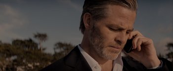 Movie still from “All the Old Knives” (2022), directed by Janus Metz – A person wearing a suit and tie; Close Up shot, Low angle