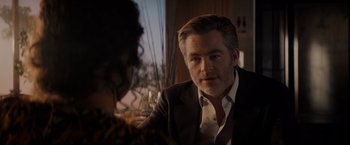 Movie still from “All the Old Knives” (2022), directed by Janus Metz – A person sitting at a table; Close Up shot, Over the shoulder angle