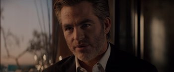 Movie still from “All the Old Knives” (2022), directed by Janus Metz – A person wearing a suit and tie; Close Up shot, Over the shoulder angle