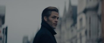 Movie still from “All the Old Knives” (2022), directed by Janus Metz – A man in a black jacket is looking at the camera; Close Up shot, Low angle