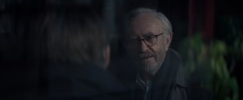 Movie still from “All the Old Knives” (2022), directed by Janus Metz – An older man wearing glasses talking to a younger man; Close Up shot, Over the shoulder angle