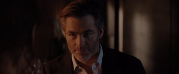 Movie still from “All the Old Knives” (2022), directed by Janus Metz – A person wearing a suit and tie; Close Up shot, Over the shoulder angle