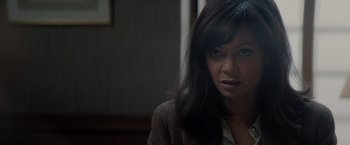 Movie still from “All the Old Knives” (2022), directed by Janus Metz – A person with long black hair; Close Up shot, Over the shoulder angle