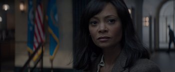 Movie still from “All the Old Knives” (2022), directed by Janus Metz – A person wearing a suit; Close Up shot, Over the shoulder angle