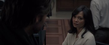 Movie still from “All the Old Knives” (2022), directed by Janus Metz – A woman in a white jacket talking to a man in glasses; Close Up shot, Over the shoulder angle