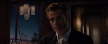 Movie still from “All the Old Knives” (2022), directed by Janus Metz – A person wearing a suit and tie; Close Up shot, Over the shoulder angle