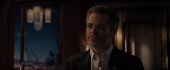 Movie still from “All the Old Knives” (2022), directed by Janus Metz – A person wearing a suit and tie; Close Up shot, Over the shoulder angle