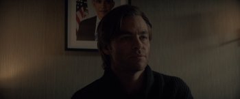 Movie still from “All the Old Knives” (2022), directed by Janus Metz – A person wearing a sweater; Close Up shot, Over the shoulder angle