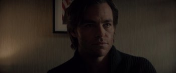 Movie still from “All the Old Knives” (2022), directed by Janus Metz – A person wearing a jacket; Close Up shot, Over the shoulder angle