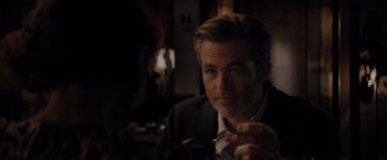 Movie still from “All the Old Knives” (2022), directed by Janus Metz – A person wearing a suit and tie; Close Up shot, Over the shoulder angle