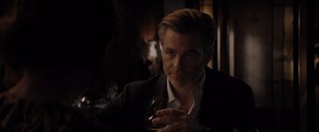 Movie still from “All the Old Knives” (2022), directed by Janus Metz – A person holding a glass of wine; Close Up shot, Over the shoulder angle