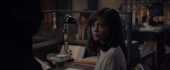 Movie still from “All the Old Knives” (2022), directed by Janus Metz – A woman sitting at a table in front of a man; Medium shot, Over the shoulder angle