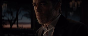 Movie still from “All the Old Knives” (2022), directed by Janus Metz – A person wearing a suit and tie; Close Up shot, Low angle