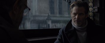 Movie still from “All the Old Knives” (2022), directed by Janus Metz – A man sitting on a bus looking out the window; Close Up shot, Low angle