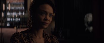 Movie still from “All the Old Knives” (2022), directed by Janus Metz – A person wearing a necklace; Close Up shot, Over the shoulder angle