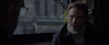 Movie still from “All the Old Knives” (2022), directed by Janus Metz – A person sitting in front of a window; Close Up shot, Over the shoulder angle