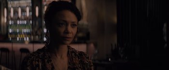 Movie still from “All the Old Knives” (2022), directed by Janus Metz – A person wearing a brown shirt; Close Up shot, Over the shoulder angle